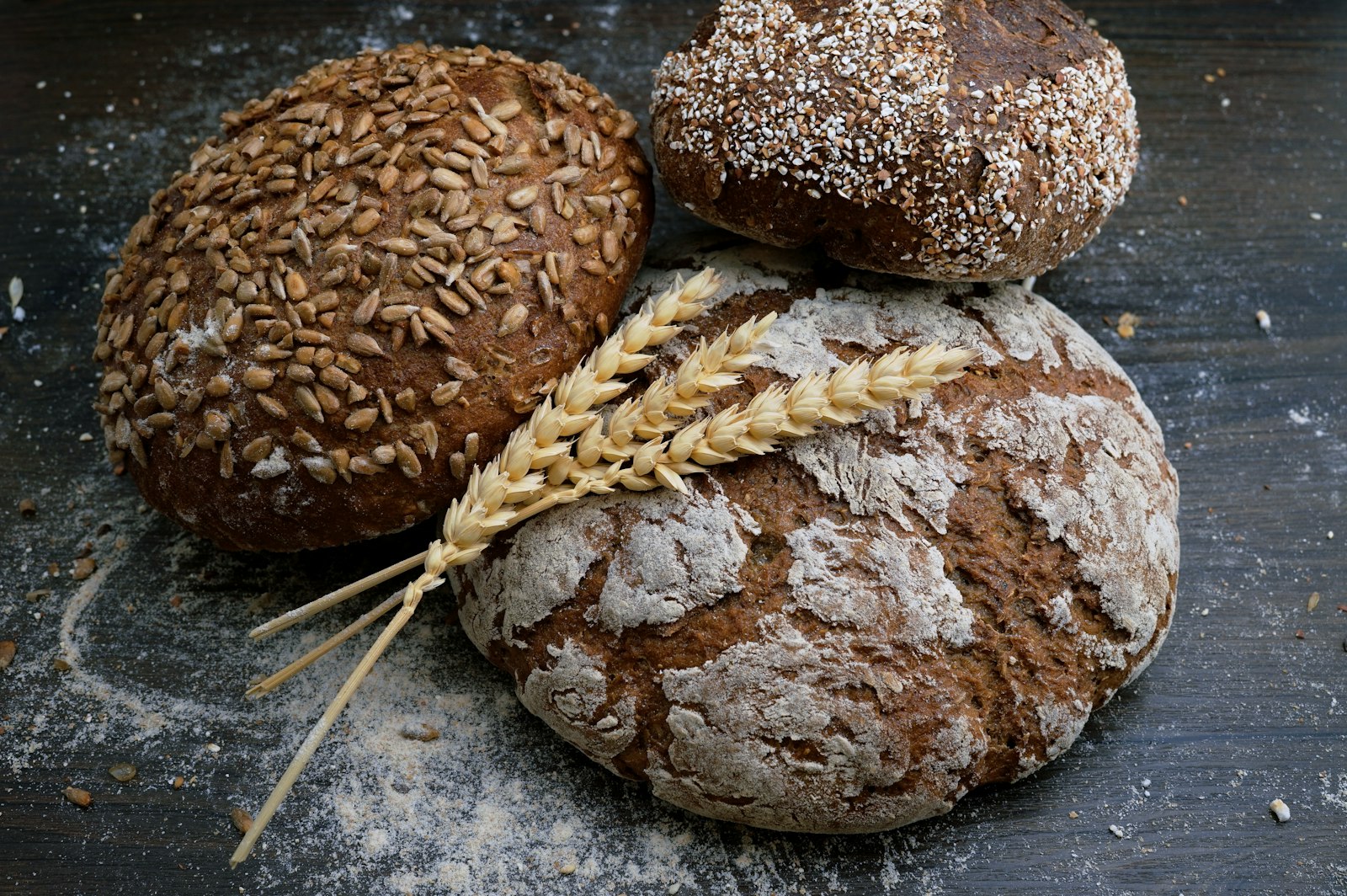 Freshly baked artisan loaves on a floured wooden table
