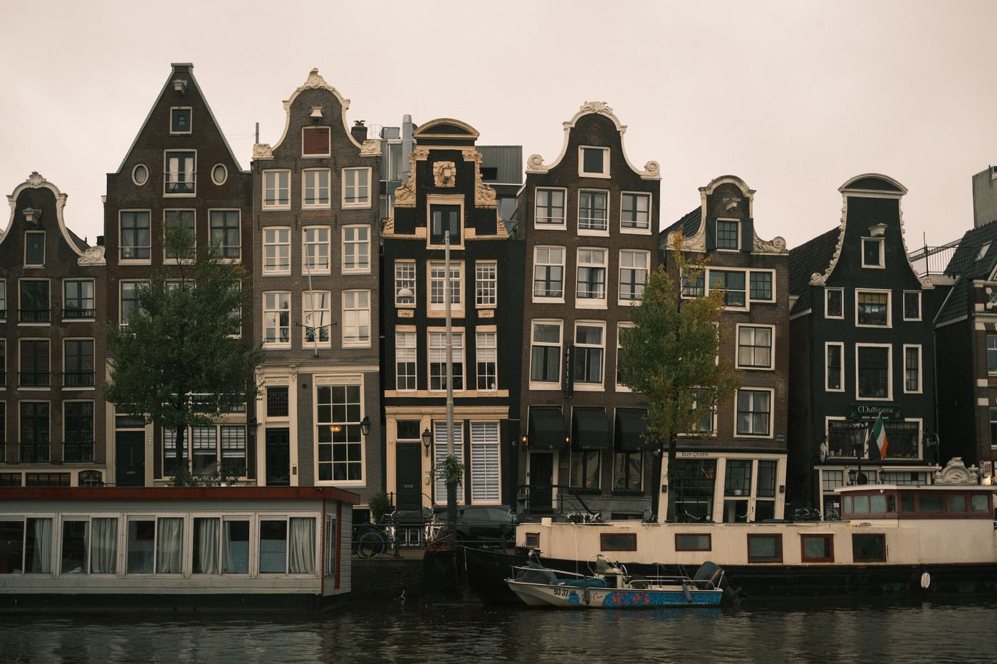 Gabled canal houses along the water in Amsterdam